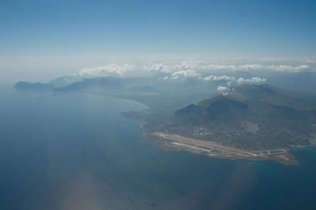 The airport by the sea, among mountains, seen from the air