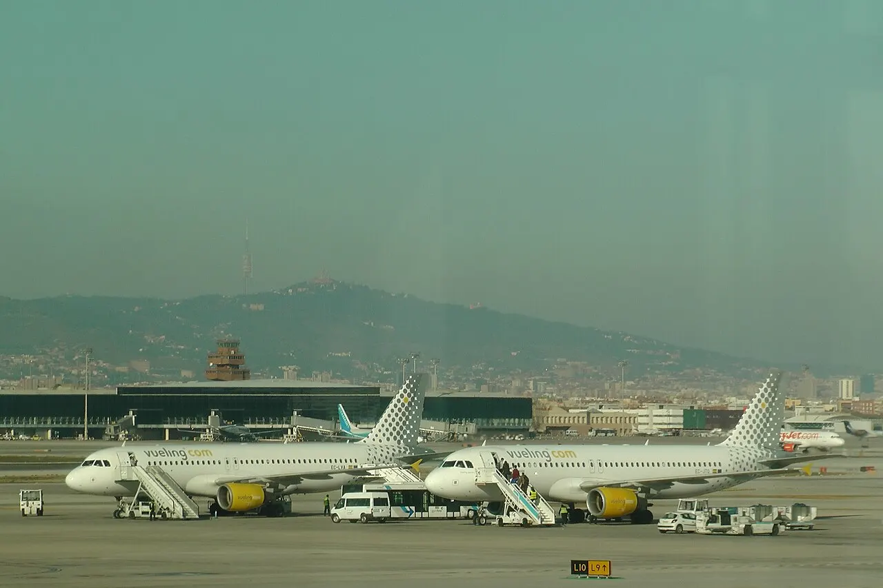 Aircraft on the apron with the Collserola hills behind