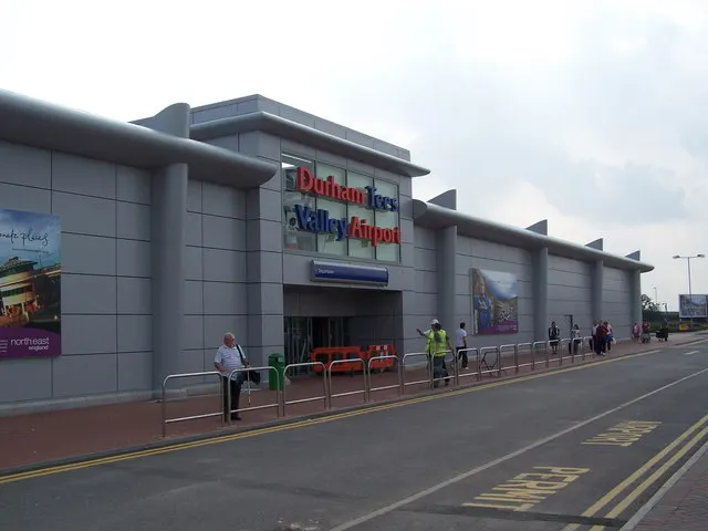 The terminal entrance, with passengers walking by