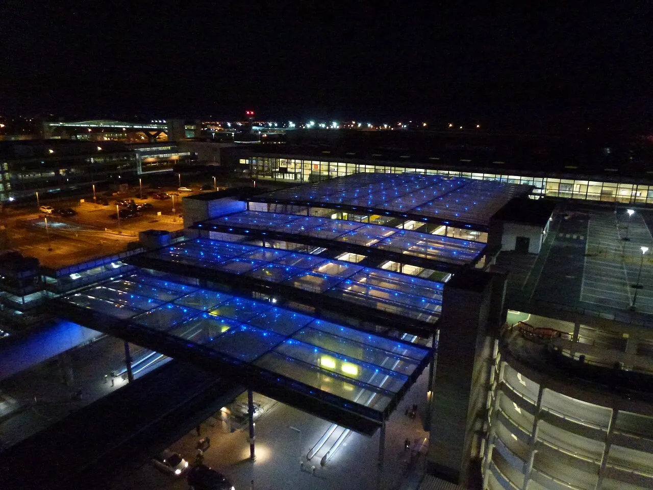 Airport buildings lit up at dusk