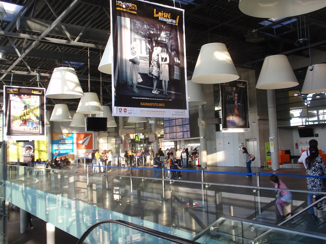Inside the terminal, by the escalators
