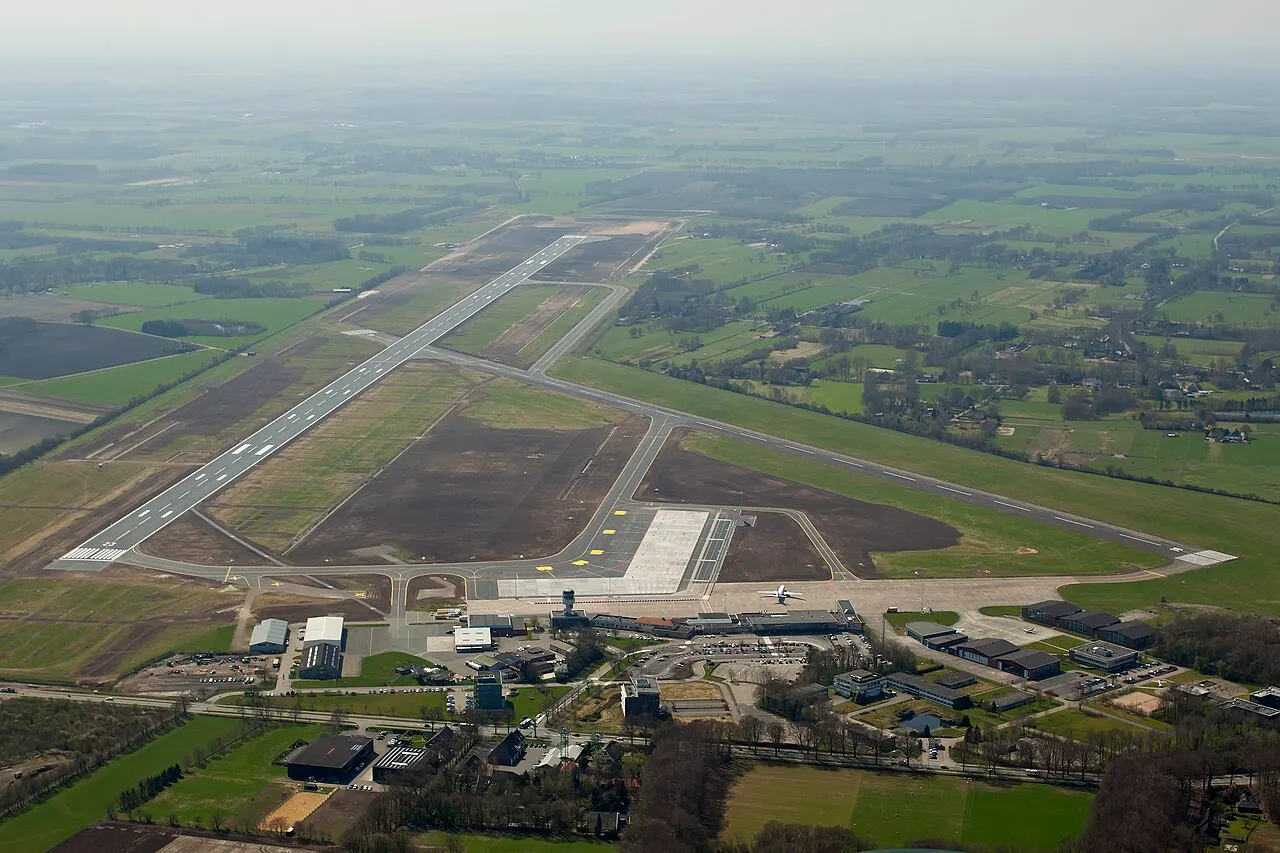 The airport from the air, with the runway and terminal surrounded by fields