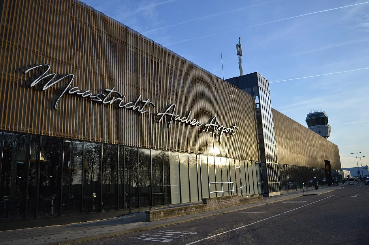 The terminal building, with its dark façade and the control tower behind