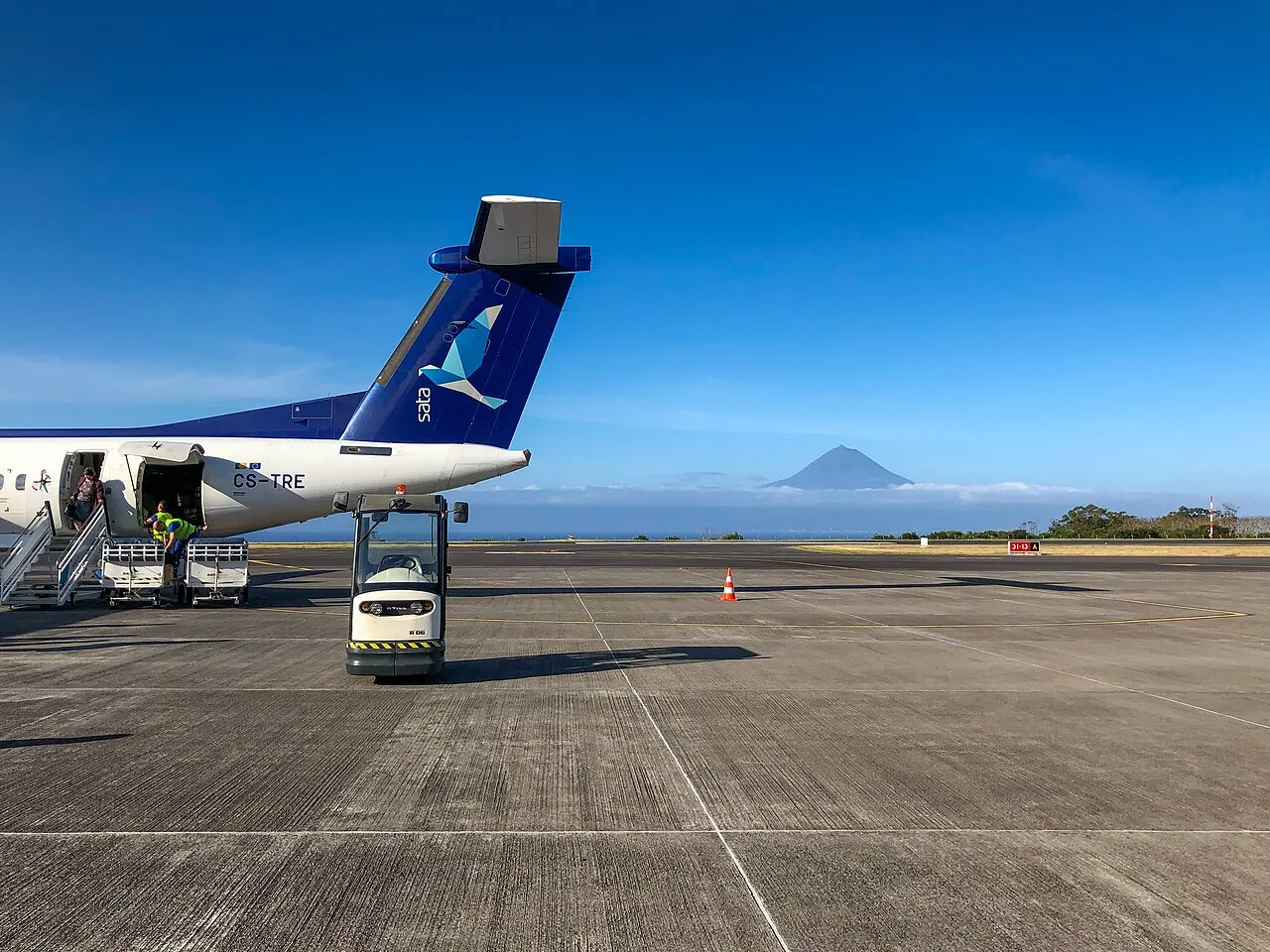 A SATA Dash 8 on the apron, with Pico mountain in the distance