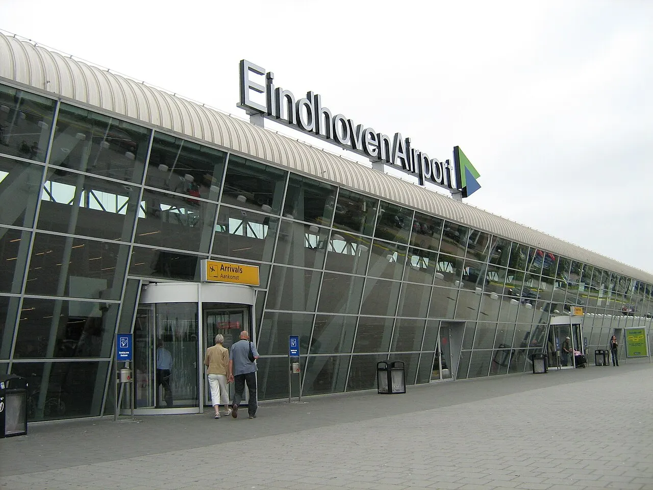The glazed front of the terminal with the airport sign